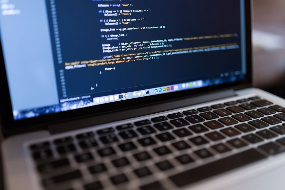 Comparison of AI website builder interface and traditional WordPress dashboard on laptop screens